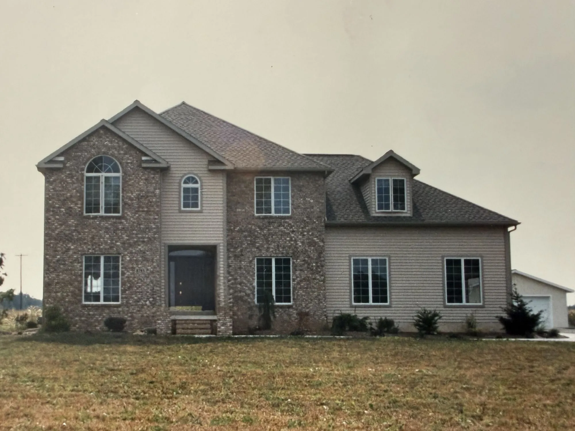 A brick and siding two story home, built by the Strouss family