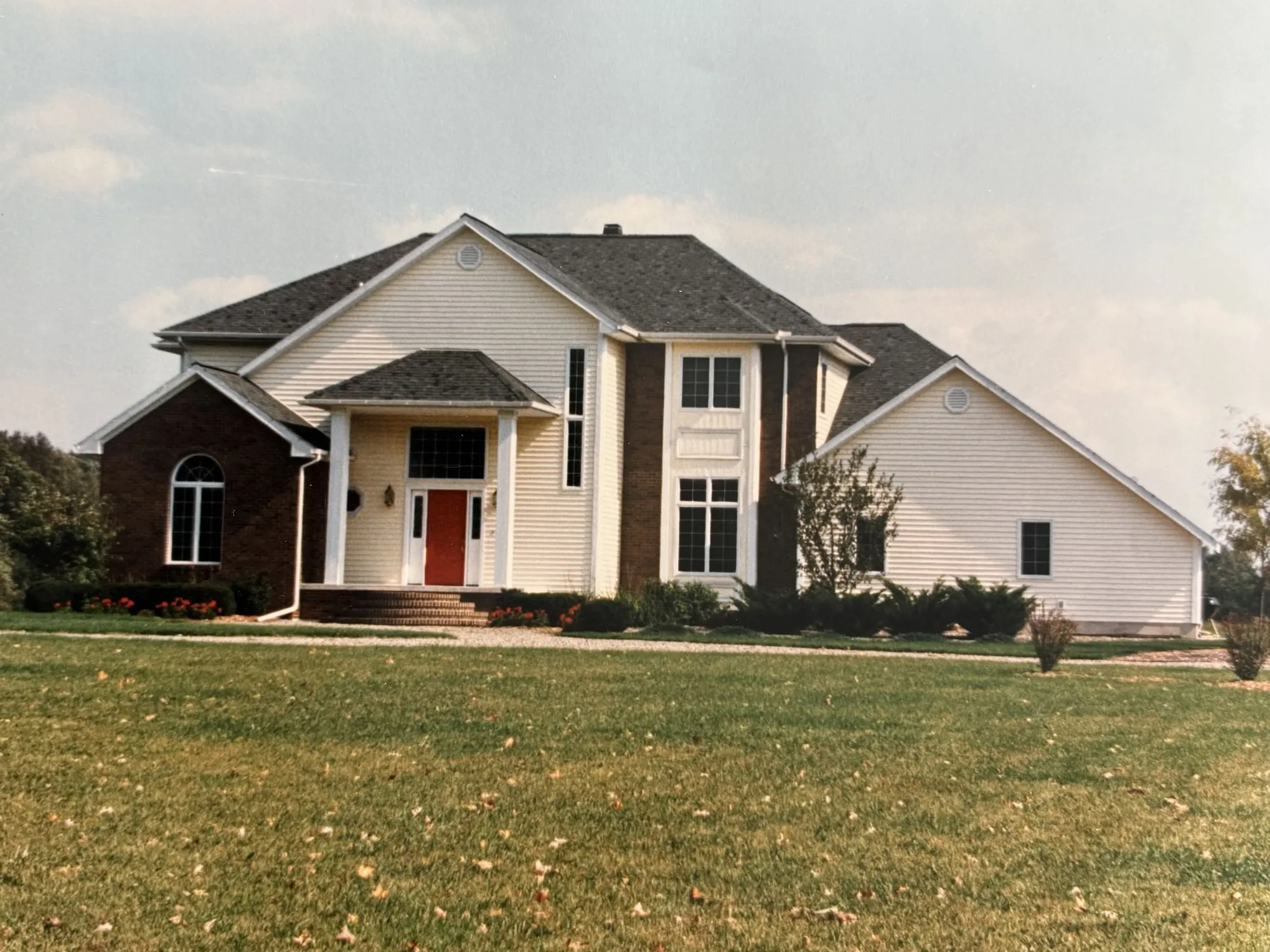 A cream and brick two story home, built by the Strouss family