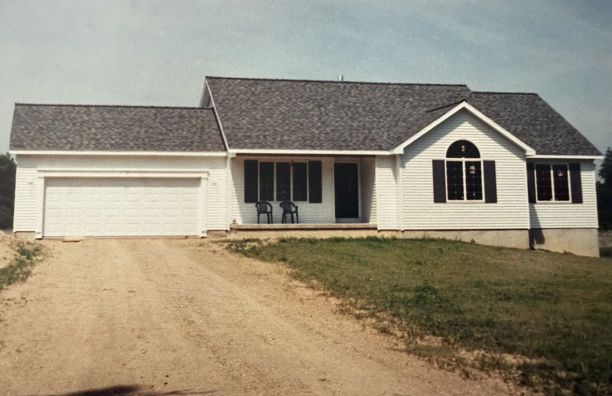 A white ranch with a covered front porch, built by the Strouss family